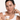 A model holds a jar of IMAGE Skincare VITAL C hydrating overnight masque against a white background.